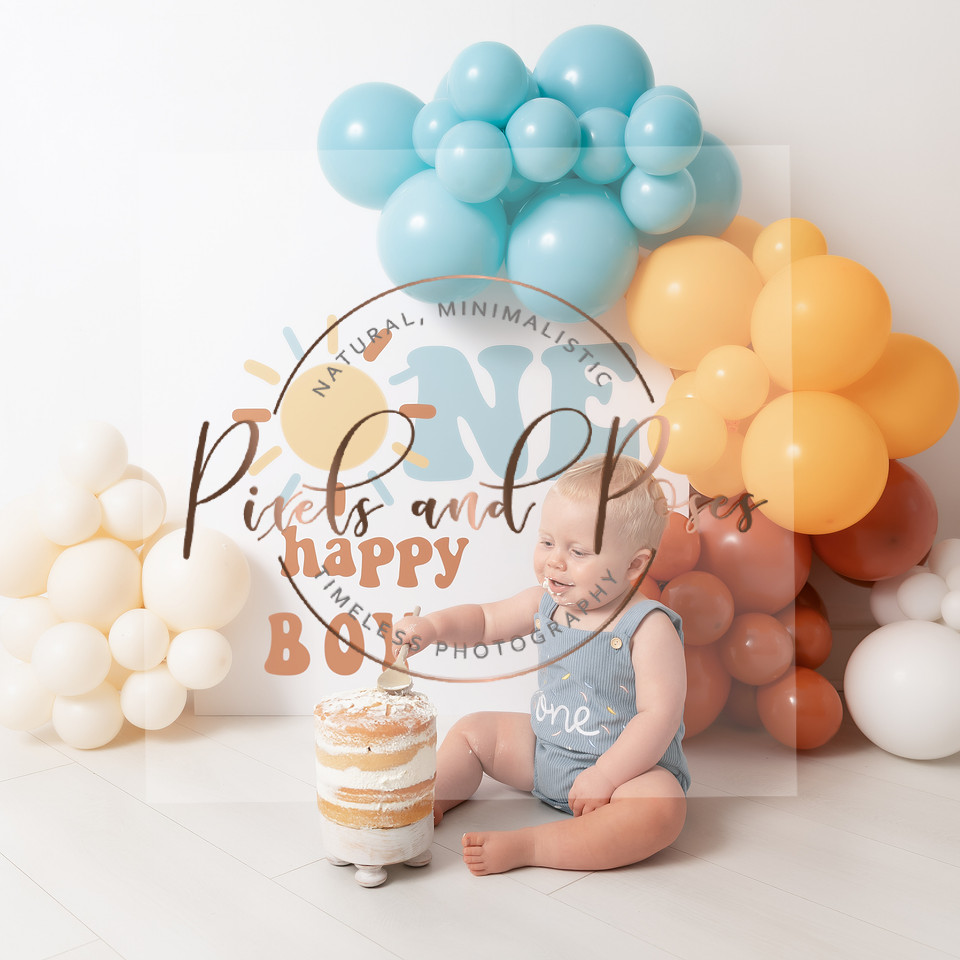 One Happy Boy cake smash session with soft balloon styling.