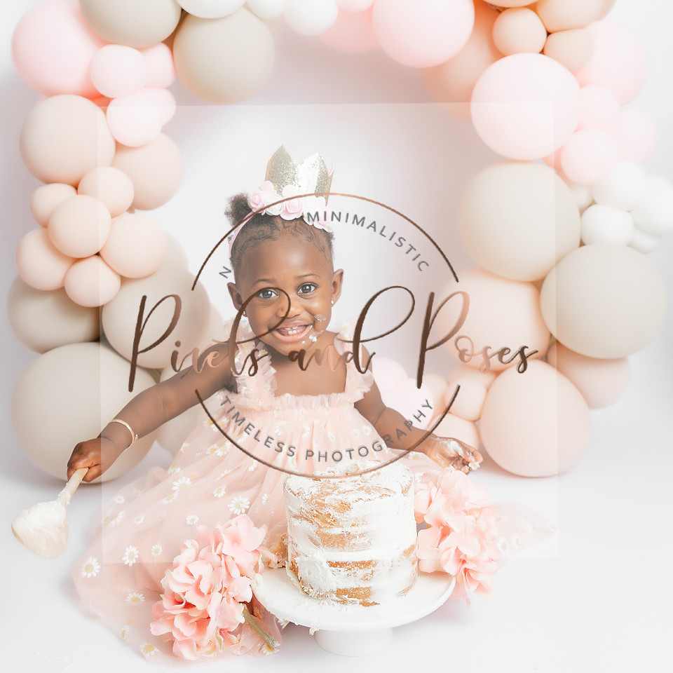 Muted pink and soft beige balloon hoop cake smash setup for first birthday photoshoot
