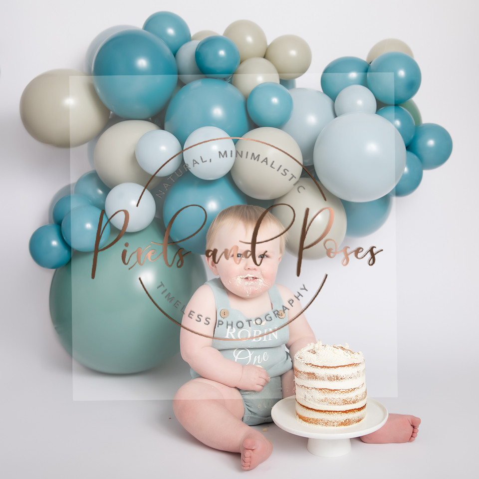 Soft blue balloon styling for a timeless first birthday cake smash session.