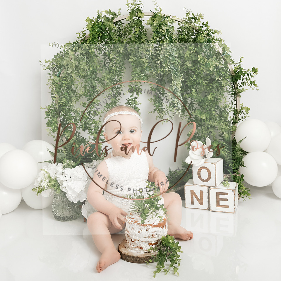Greenery cake smash first birthday photoshoot with trailing ivy in Derbyshire studio